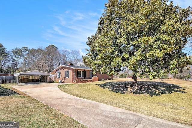 view of front of home featuring a detached carport, driveway, a chimney, and brick siding