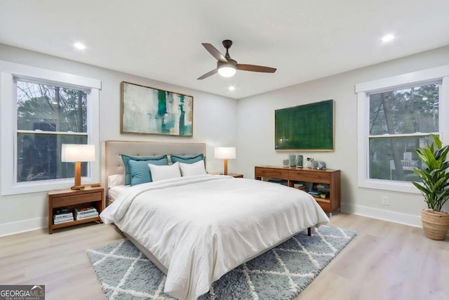 bedroom featuring recessed lighting, light wood-type flooring, and baseboards