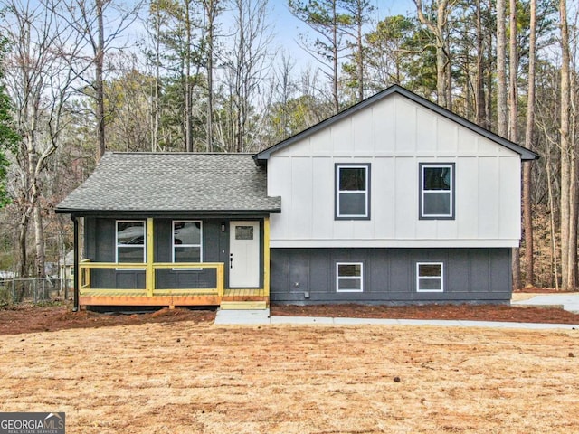 split level home with a shingled roof and board and batten siding