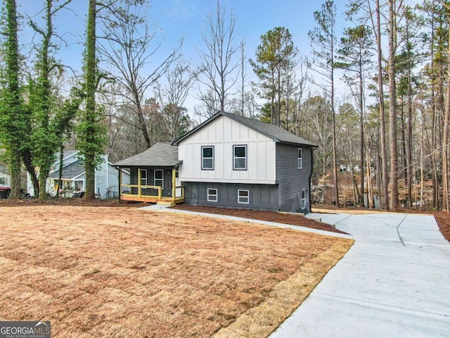 view of front facade featuring a shingled roof and board and batten siding