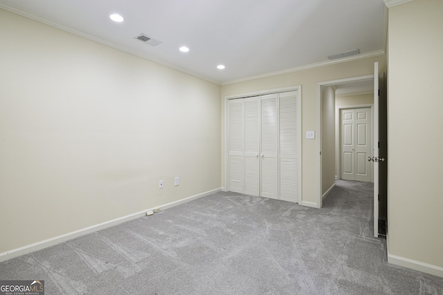 unfurnished bedroom with visible vents, crown molding, carpet flooring, a closet, and recessed lighting