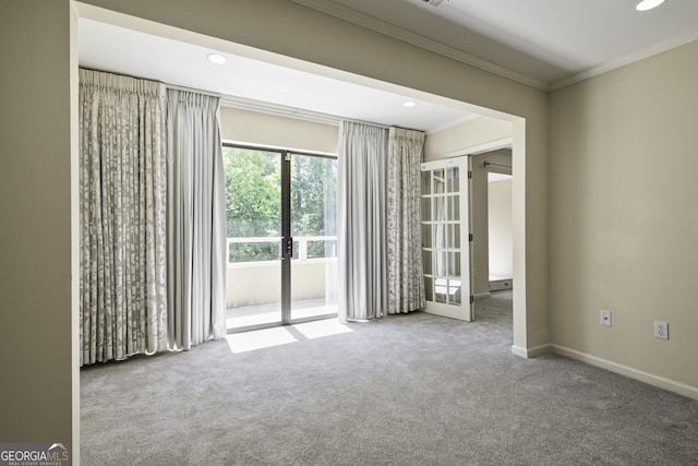 spare room with ornamental molding, french doors, carpet, and baseboards