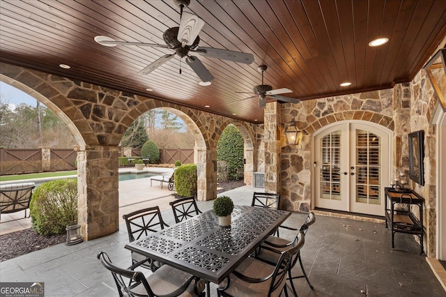 view of patio with a ceiling fan, a fenced in pool, fence, outdoor dining area, and french doors