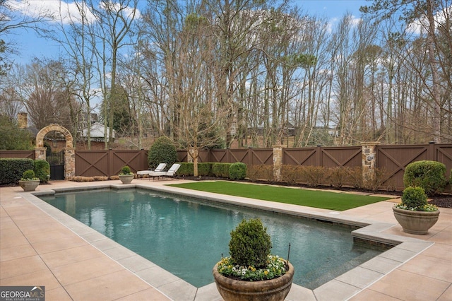 view of swimming pool with a fenced in pool, a gate, fence, and a patio