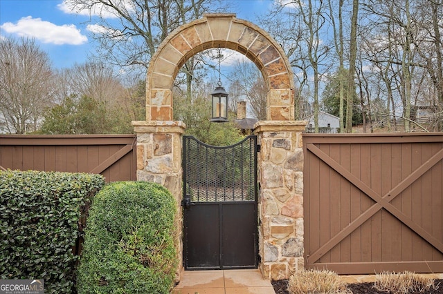 view of gate with fence