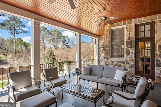 sunroom with a ceiling fan and outdoor lounge area