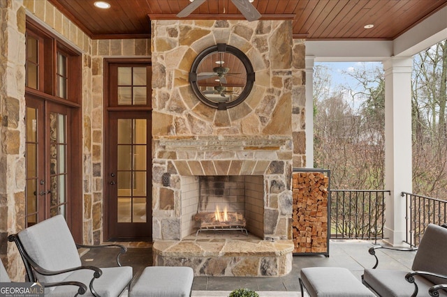 living area featuring french doors, an outdoor stone fireplace, wood ceiling, and recessed lighting