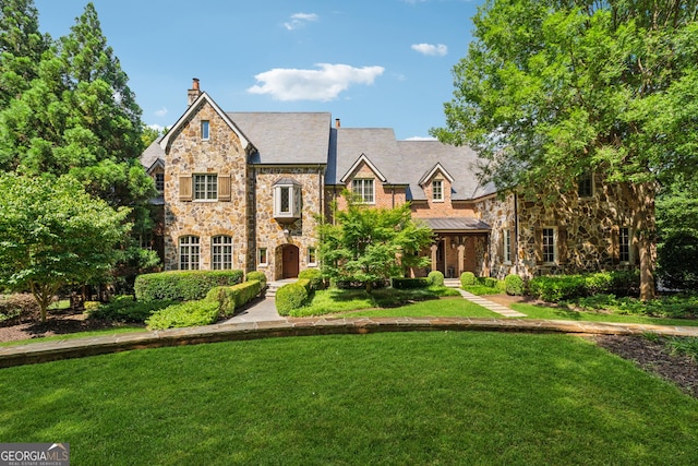 13940 Haystack Ln, Milton, GA 30004 - view of front facade featuring stone siding, a front lawn, and a chimney