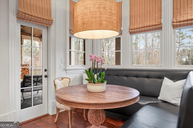 dining area featuring dark wood-style floors and breakfast area