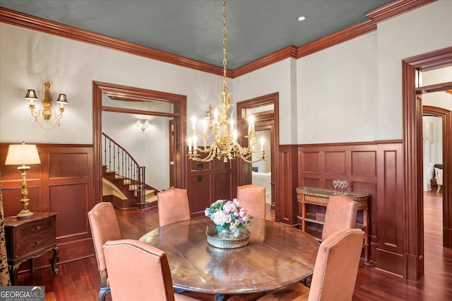 dining space with ornamental molding, stairway, wainscoting, dark wood finished floors, and an inviting chandelier