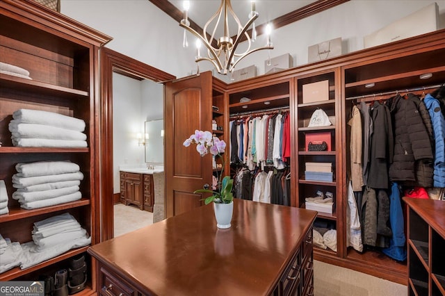 walk in closet with a chandelier, light carpet, and a sink