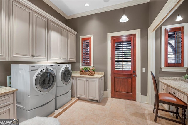 clothes washing area with cabinet space, light tile patterned floors, baseboards, independent washer and dryer, and crown molding