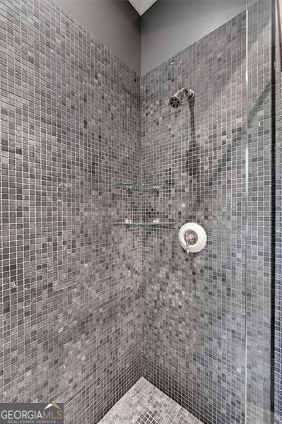 full bath with a tile shower