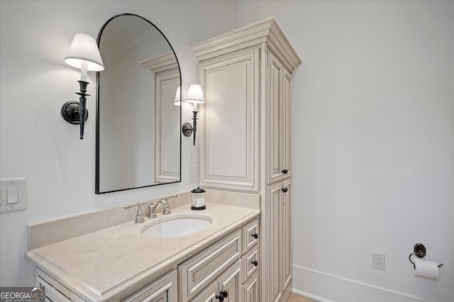 bathroom with baseboards and vanity