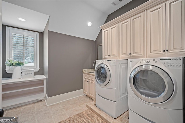 laundry room with cabinet space, light tile patterned floors, visible vents, baseboards, and washing machine and dryer