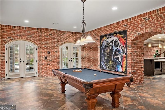 recreation room with french doors, brick wall, billiards, stone finish floors, and recessed lighting