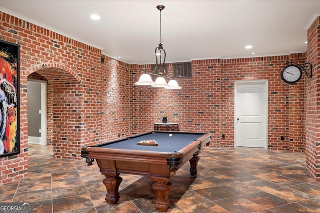 rec room with recessed lighting, stone finish floor, and brick wall