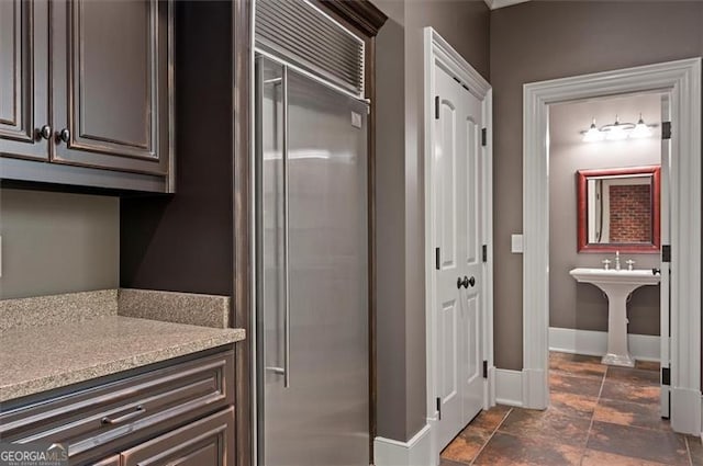 bathroom with baseboards and a sink