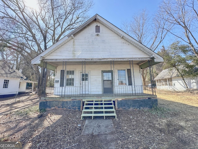 bungalow-style home with fence and a porch