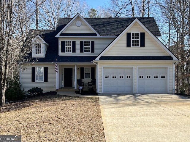 traditional home featuring a garage, a porch, and concrete driveway