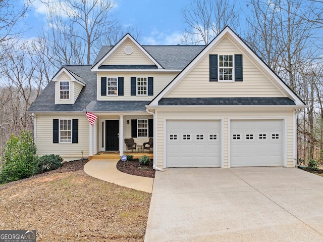 traditional-style home featuring a shingled roof, a porch, and concrete driveway