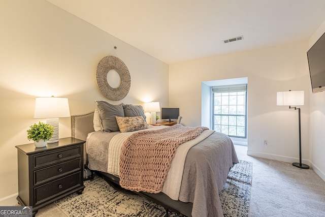 bedroom featuring light carpet, visible vents, and baseboards