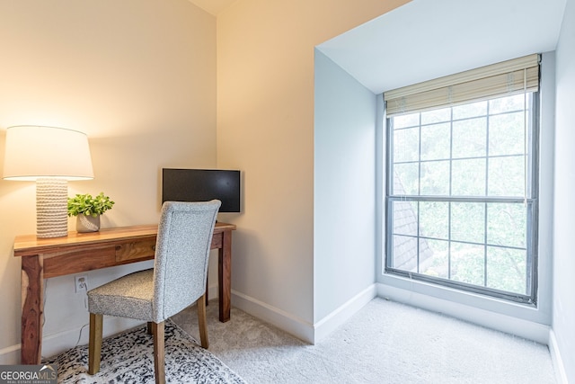 carpeted office space featuring a wealth of natural light and baseboards