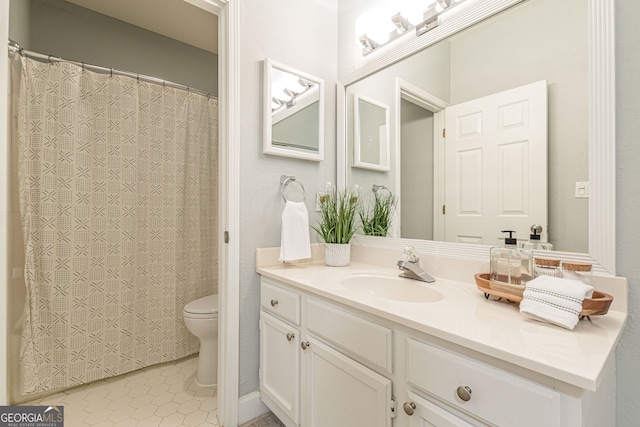 full bath featuring curtained shower, vanity, toilet, and tile patterned floors