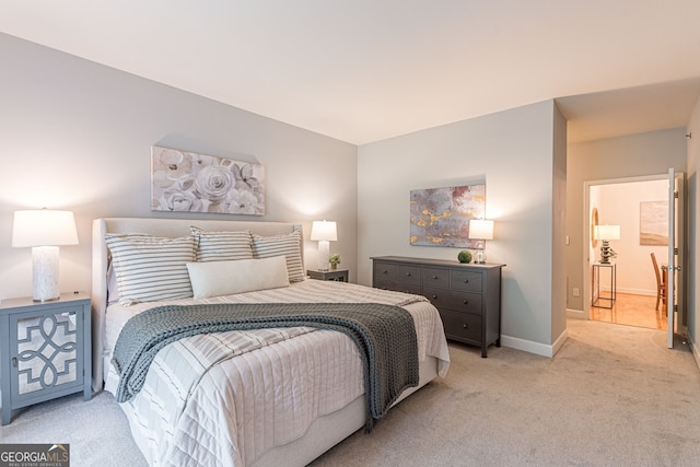 bedroom with baseboards and light colored carpet