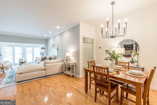 dining room with light wood-style floors, baseboards, and ornamental molding