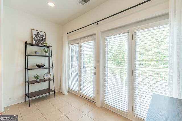 doorway to outside featuring recessed lighting, baseboards, visible vents, and light tile patterned flooring