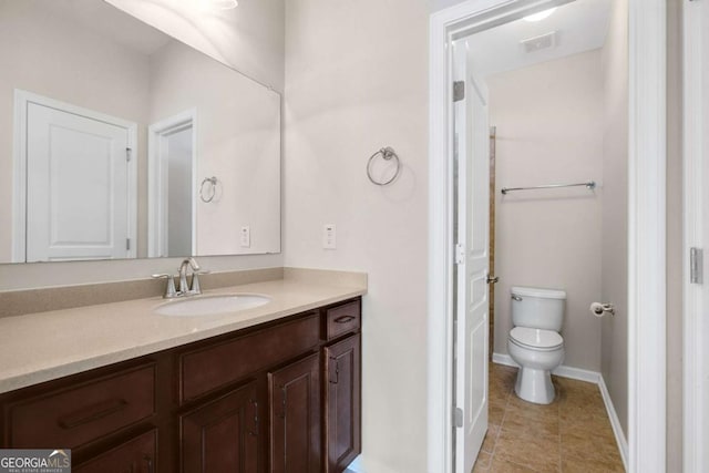 bathroom featuring baseboards, visible vents, toilet, tile patterned flooring, and vanity