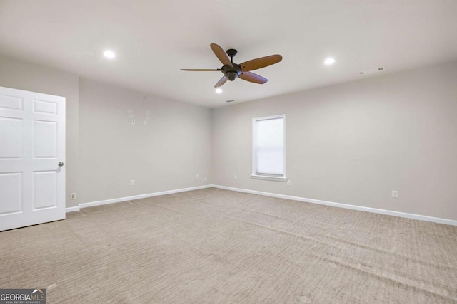 empty room featuring carpet, baseboards, and recessed lighting