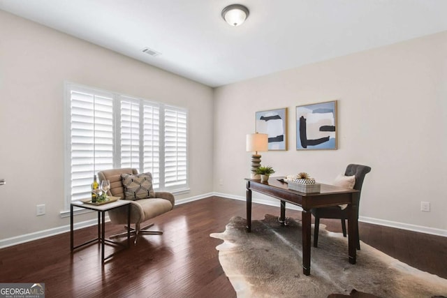 office space featuring visible vents, baseboards, and wood finished floors