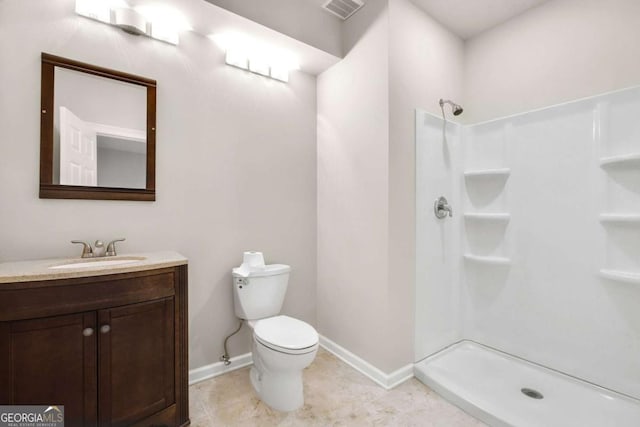 bathroom featuring a shower, visible vents, toilet, vanity, and baseboards