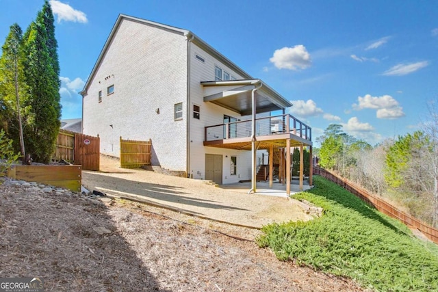 rear view of property featuring a patio area, a fenced backyard, stairway, and a deck