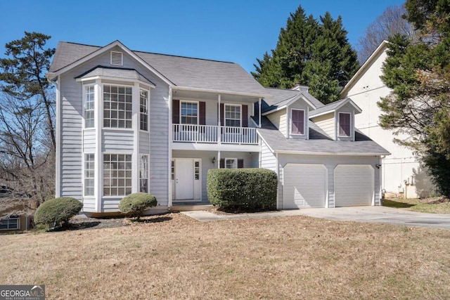 view of front of house featuring driveway, a balcony, a garage, and a front lawn