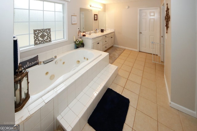 full bathroom featuring baseboards, a jetted tub, vanity, and tile patterned floors