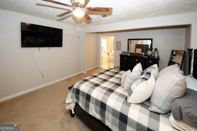 bedroom with visible vents, light carpet, a textured ceiling, and baseboards