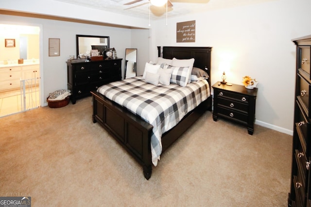 bedroom featuring connected bathroom, a ceiling fan, and light colored carpet