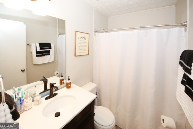 full bath featuring a textured ceiling, vanity, and toilet