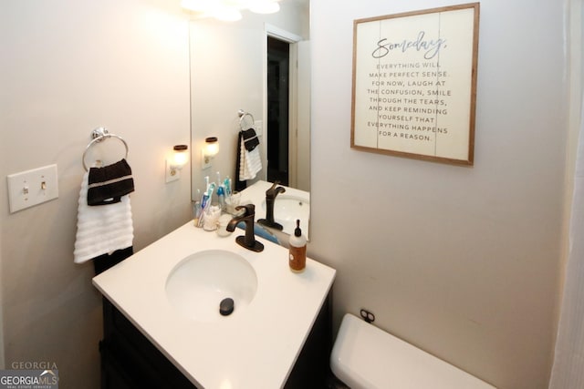 bathroom featuring toilet and vanity