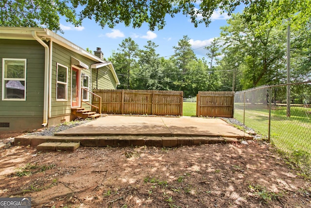 view of yard with entry steps, a patio area, and fence