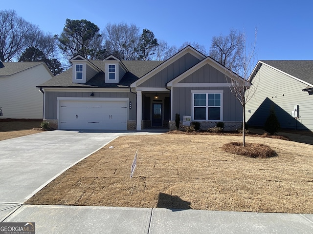 craftsman-style home with an attached garage, brick siding, driveway, roof with shingles, and board and batten siding