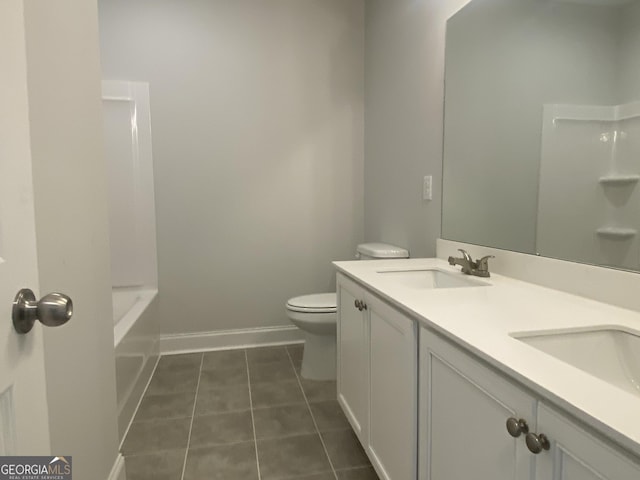 full bath with double vanity, toilet, a sink, tile patterned flooring, and baseboards