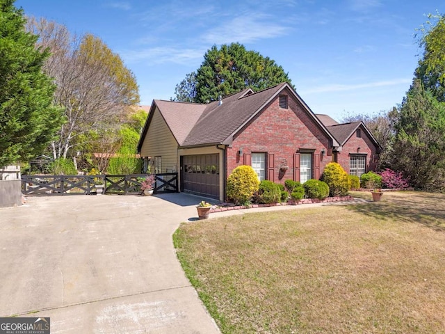 view of front of property featuring brick siding, concrete driveway, fence, a garage, and a front lawn