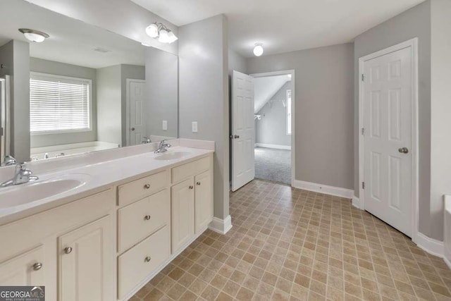 bathroom featuring a bath, double vanity, baseboards, and a sink