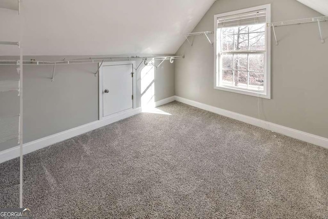 spacious closet with carpet floors and lofted ceiling