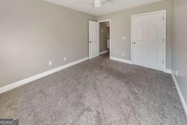 unfurnished bedroom with a ceiling fan, carpet, and baseboards