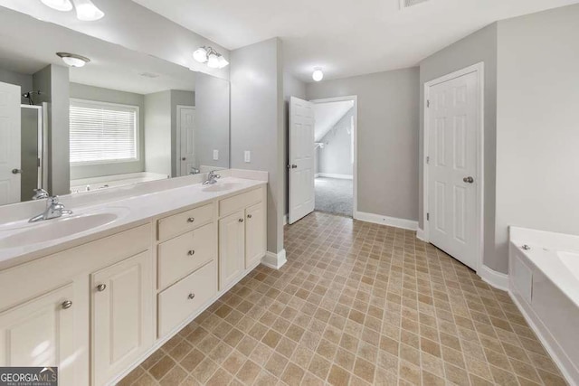 bathroom featuring a bath, double vanity, baseboards, and a sink